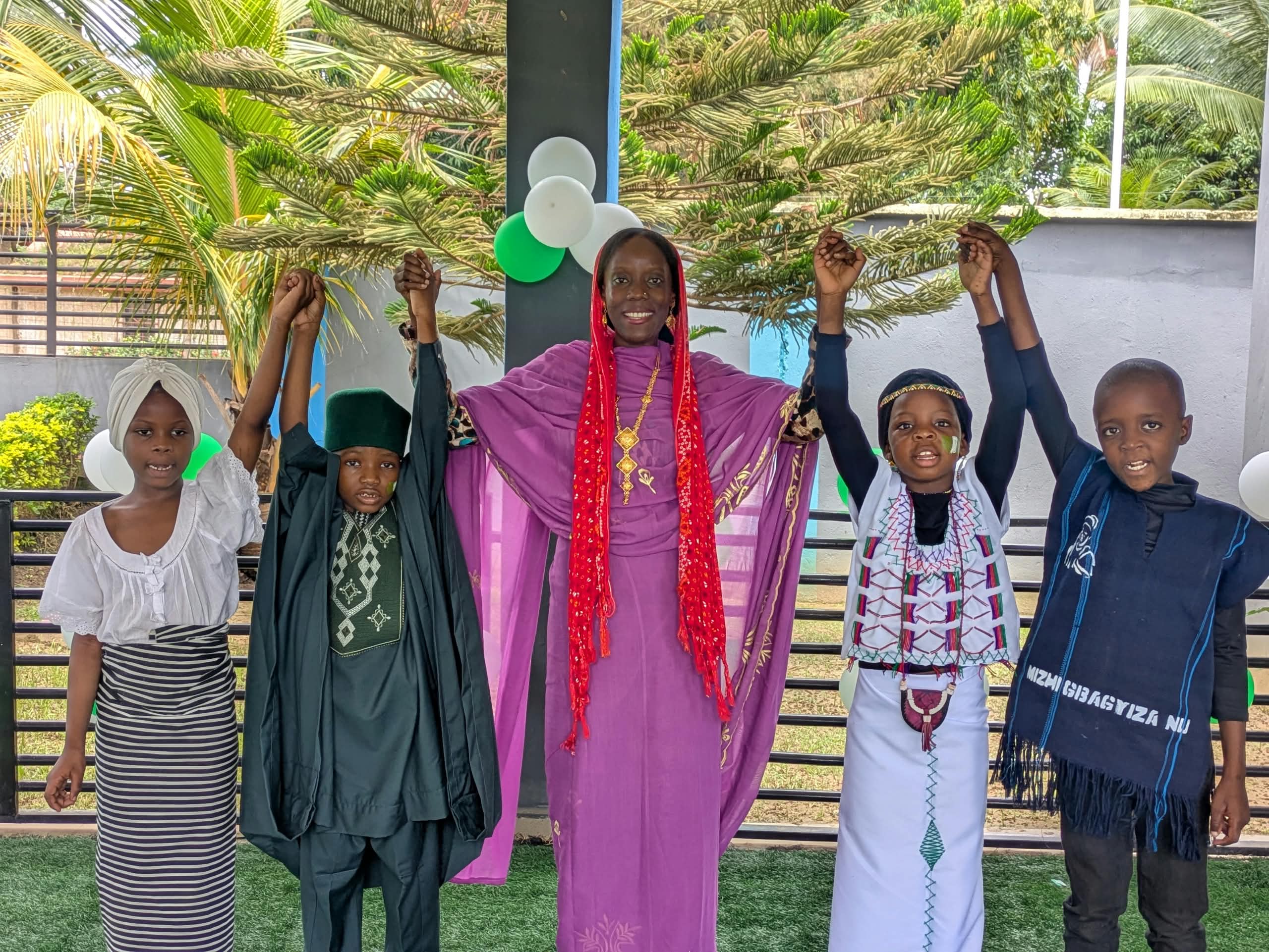 An-Nur teacher and students in cultural attire celebrating at school, Kaduna